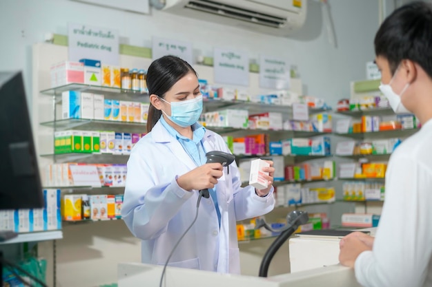 Portrait of female pharmacist wearing face mask in a modern pharmacy drugstore