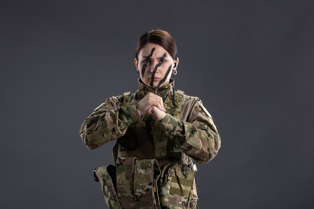 Portrait of female soldier in camouflage suit