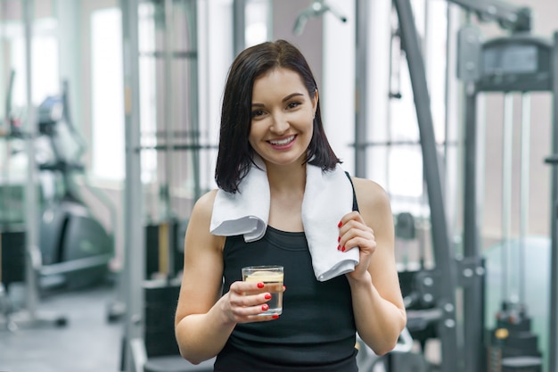 Portrait of fitness woman with glass of water with lemon