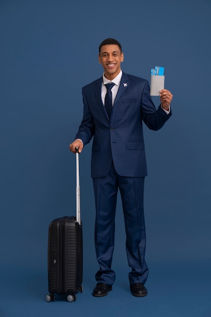 Portrait of flight attendant with luggage and plane tickets