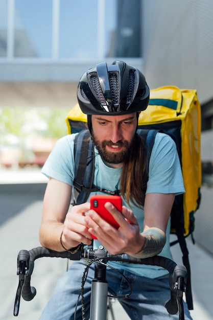 portrait of food delivery man with mobile phone