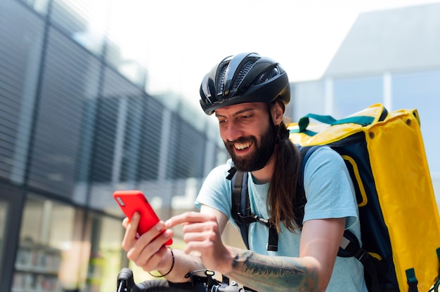 portrait of food delivery man with mobile phone