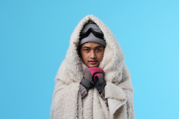 Portrait of freezing young asian man in winter