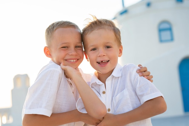 Portrait of friendly and cheerful brothers at sunset on the island of Santorini Greece