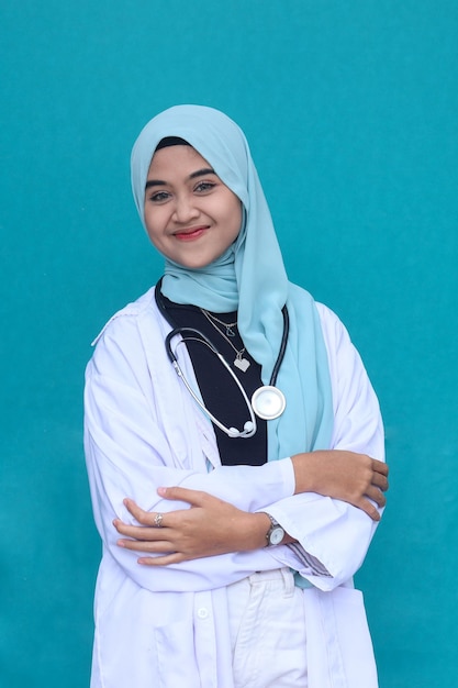 Portrait of friendly smiling confident muslim female doctor with a stethoscope in a white coat.