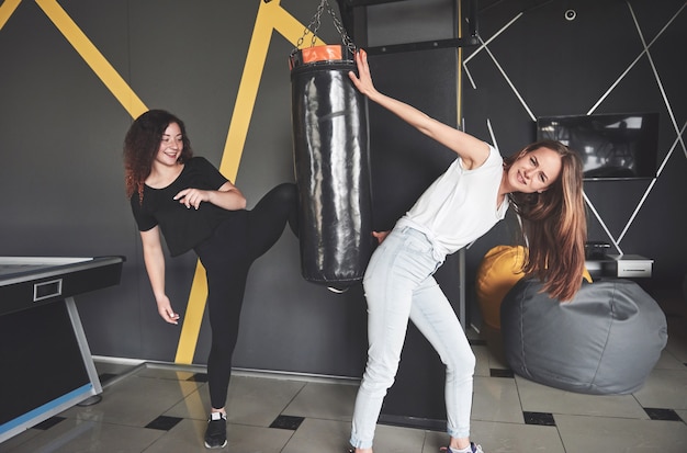 Portrait of fun boxers dressed in jeans and t-shirts in the gaming center.