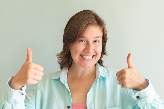 Portrait of a funny emotional girl on a blue background. Emotional happiness.