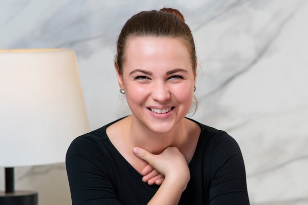 Portrait of funny laughing girl in a good mood, young beautiful woman is smiling, having fun