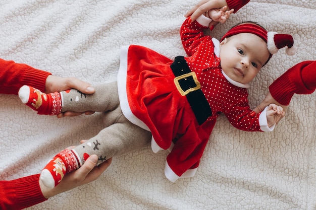 Portrait of a funny little baby girl in Christmas clothes