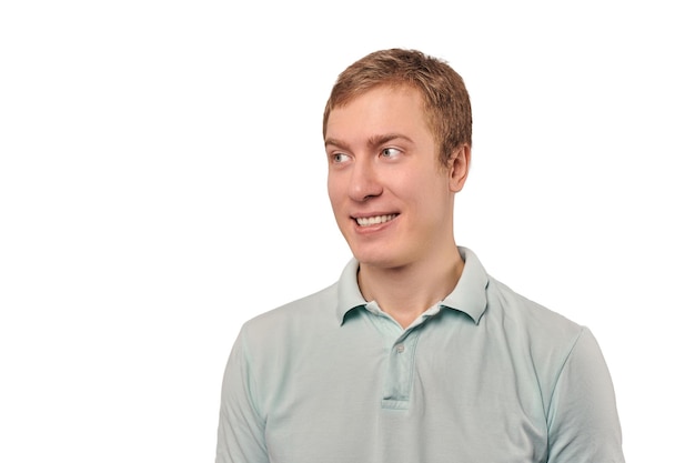 Portrait of funny young guy looking left in mint Tshirt isolated on white background