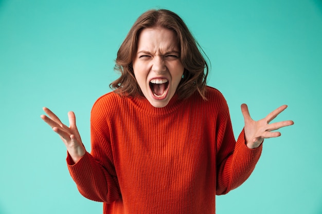 Portrait of a furious young woman dressed in sweater