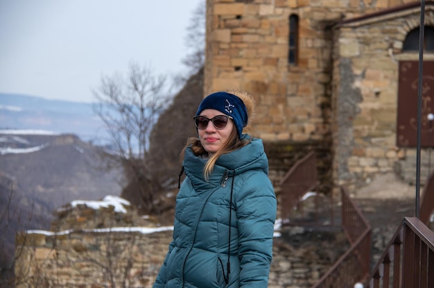 Portrait of a girl on the background of an ancient temple on the top of the mountain