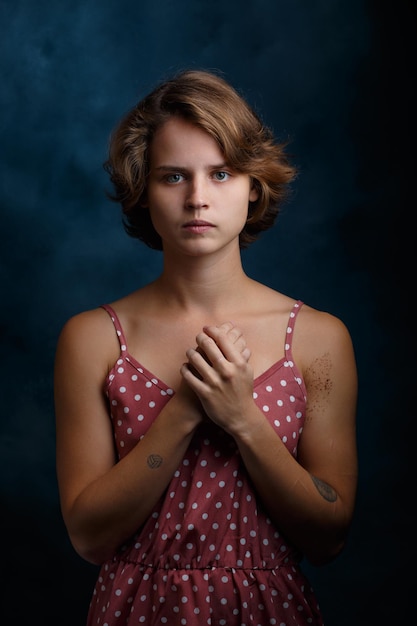 Portrait of a girl closeup on a blue background