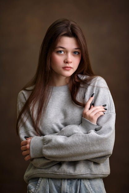 Portrait of a girl closeup a girl on a brown background a beautiful look