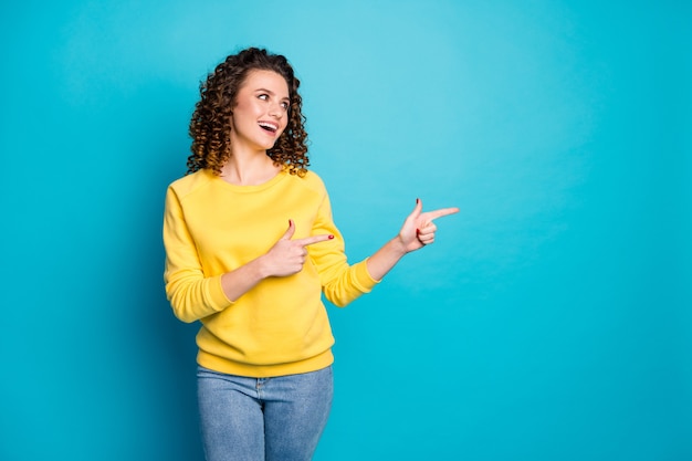 Portrait of girl demonstrating cool ad like follow subscribe isolated over blue color background