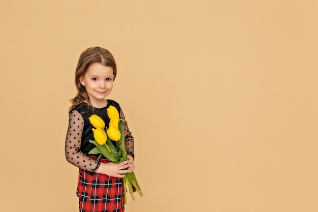 Portrait of a girl holding a bouquet of tulips