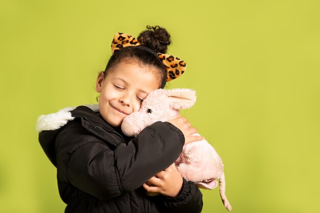 portrait girl hugging a stuffed animal