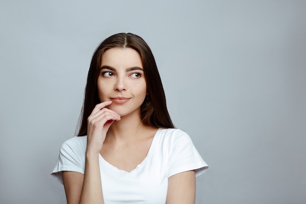 Portrait of a girl looking away on a white background