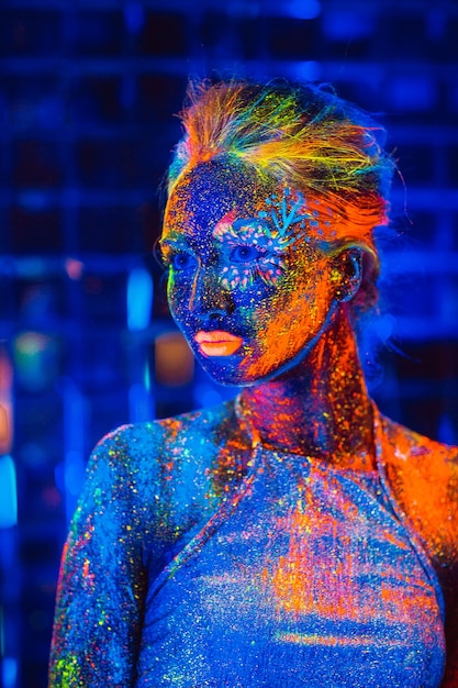 Portrait of a girl painted in fluorescent powder.