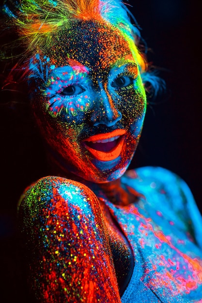 Portrait of a girl painted in fluorescent powder.