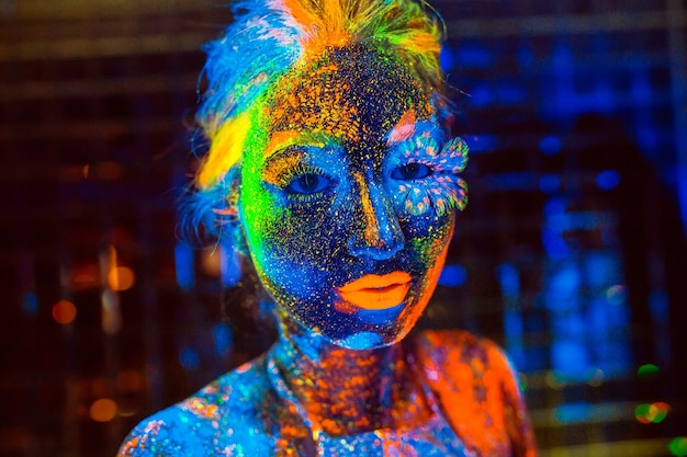 Portrait of a girl painted in fluorescent powder.