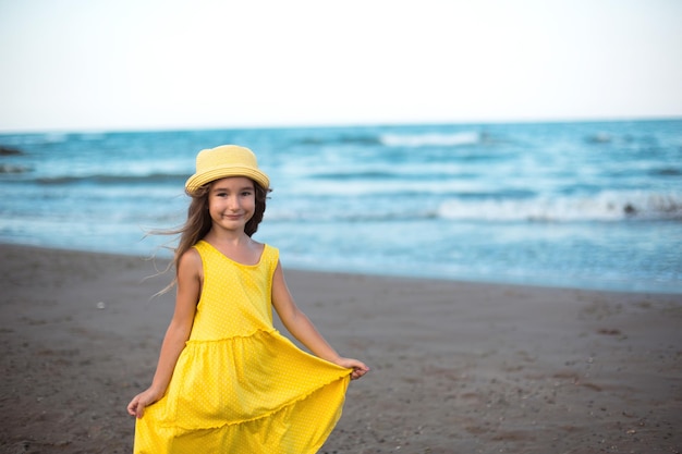 Portrait of a girl on the seashore The child enjoys the waves relaxing on the beach traveling