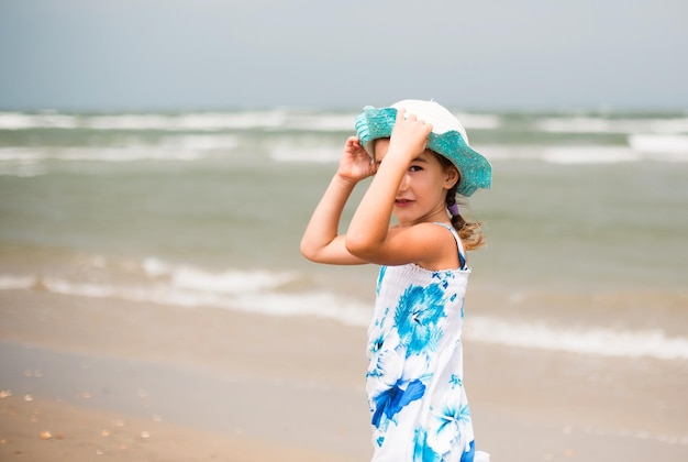 Portrait of a girl on the seashore The child enjoys the waves relaxing on the beach traveling