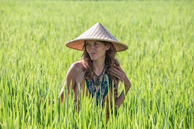 Portrait girl in a straw hat against the backdrop of a rice field in Bali Indonesia