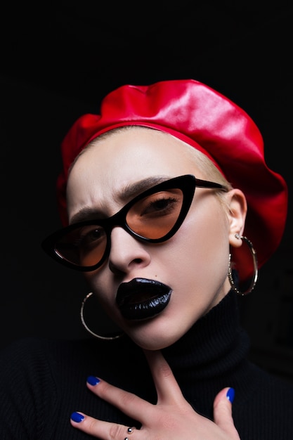 Portrait of a girl in sunglasses with black lipstick on lips