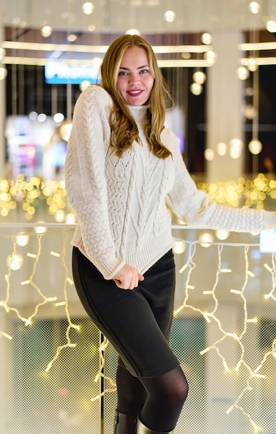 portrait of a girl in a sweater in a mall