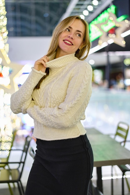 portrait of a girl in a sweater in a mall