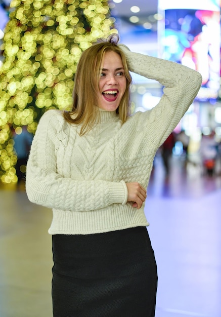 portrait of a girl in a sweater in a mall