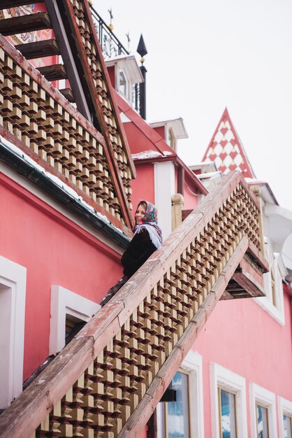 Portrait of a girl that sits on a balcony