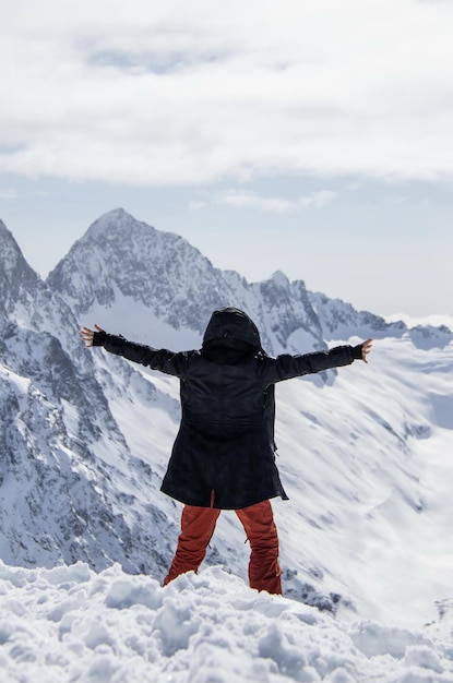 Portrait of a girl on top of a snowy mountain