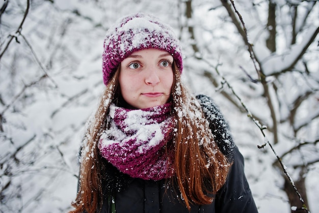 Portrait of girl at winter snowy day near snow covered trees.