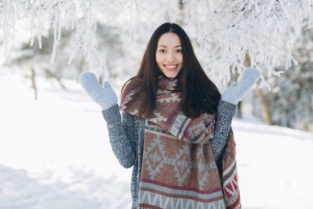 A portrait of a girl with a beautiful smile in the winter.