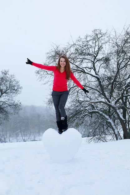 Portrait of a girl with a big snowy heart