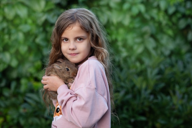 Portrait of a girl with a brown rabbit