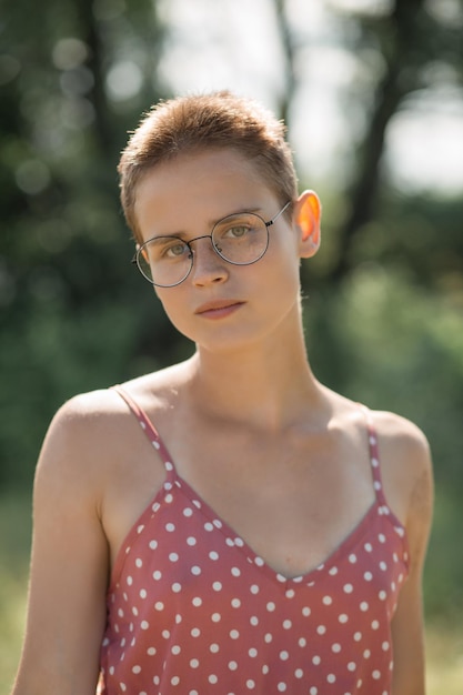 Portrait of a girl with glasses, close-up, female face, hair cutting, pleasant feelings