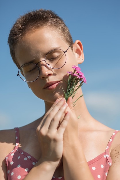 Portrait of a girl with glasses, close-up, female face, hair cutting, pleasant feelings