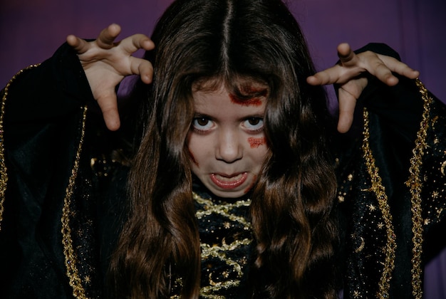 Photo portrait of a girl with halloween makeup making a scary grimace