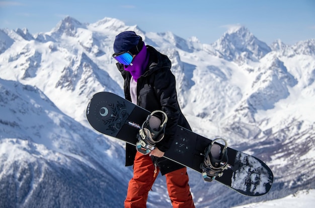 Portrait of a girl with snowboard on top of a snowy mountain.