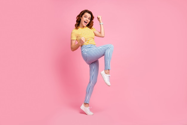 portrait of glad girl celebrating good great news isolated over pink color background