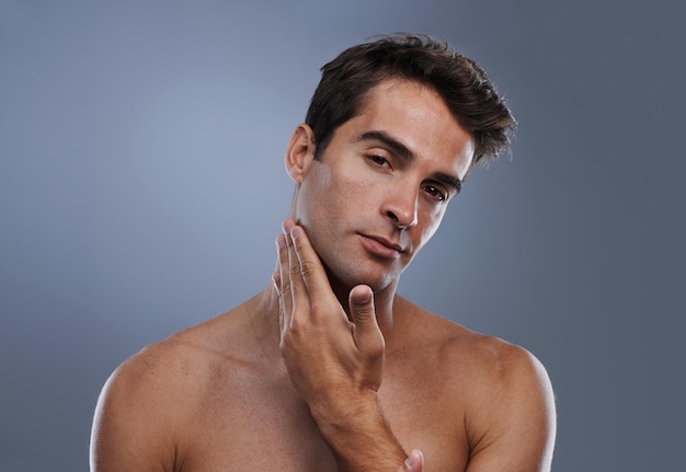 Photo portrait glow and man with skincare shaving and dermatology on grey studio background face person and model with grooming routine and healthy skin with treatment cosmetics and smooth with shine