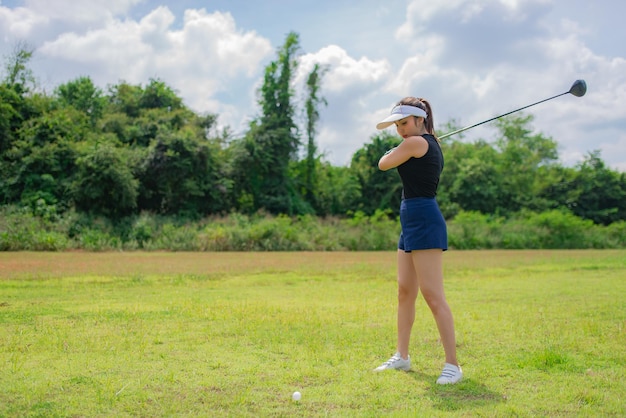 Portrait of golfer asian woman holding golf wood at the country clubHappy woman concept