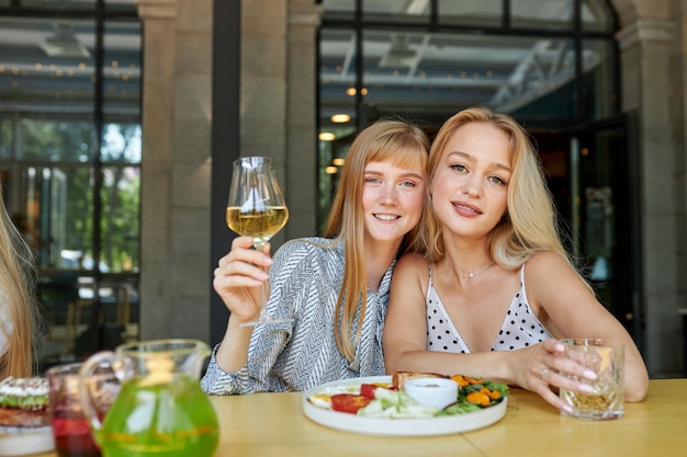 Portrait of good-looking smiling caucasian women in restaurant