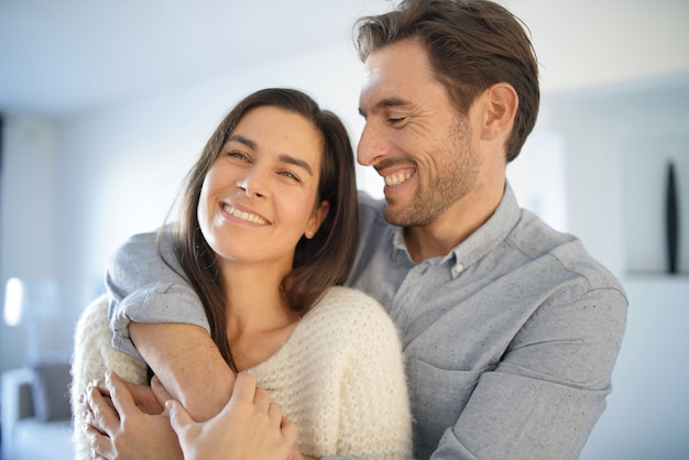  Portrait of gorgeous couple embracing at home                                                