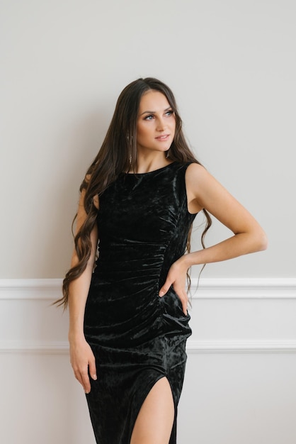 Portrait of a gorgeous elegant sensual brunette woman in a fashionable black dress Fashion photography