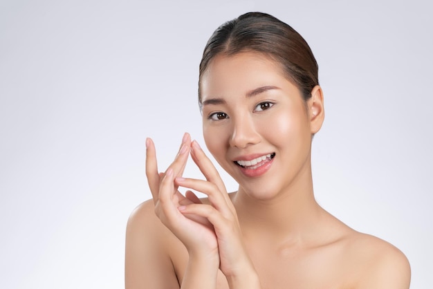 Portrait of gorgeous young girl posing beauty gesture with clean fresh skin