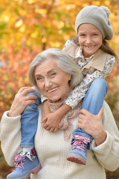 Portrait of grandmother and granddaughter hugging outdoors